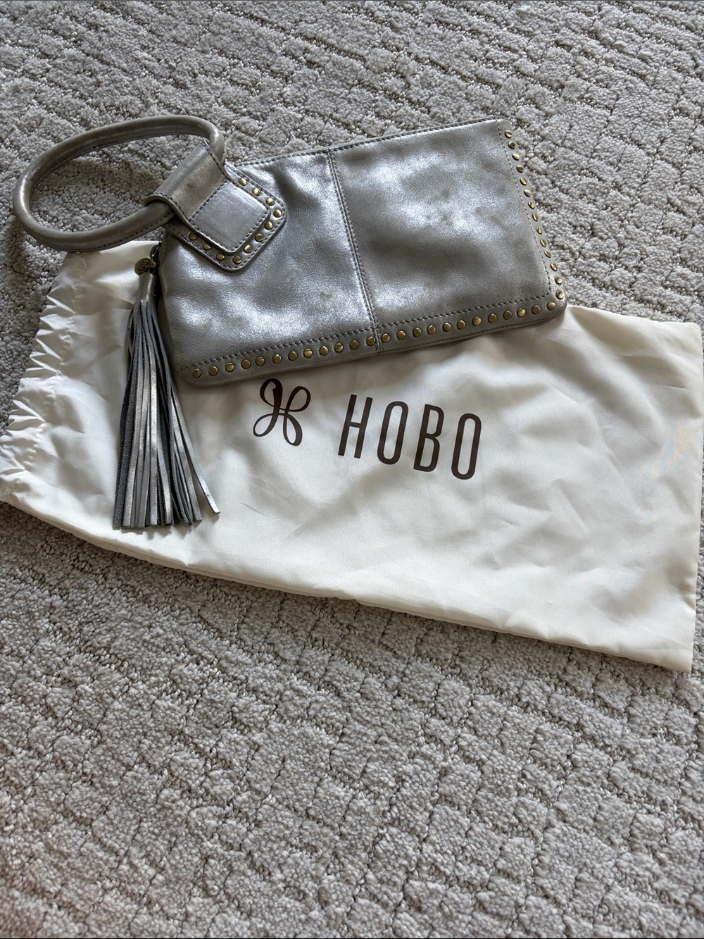 HOBO Metallic Silver Leather Wristlet with Tassel and Stud Trim